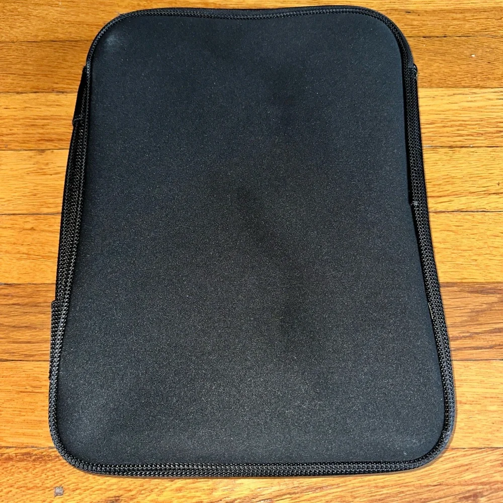 Black Belkin laptop sleeve with a zipper pocket on the front.